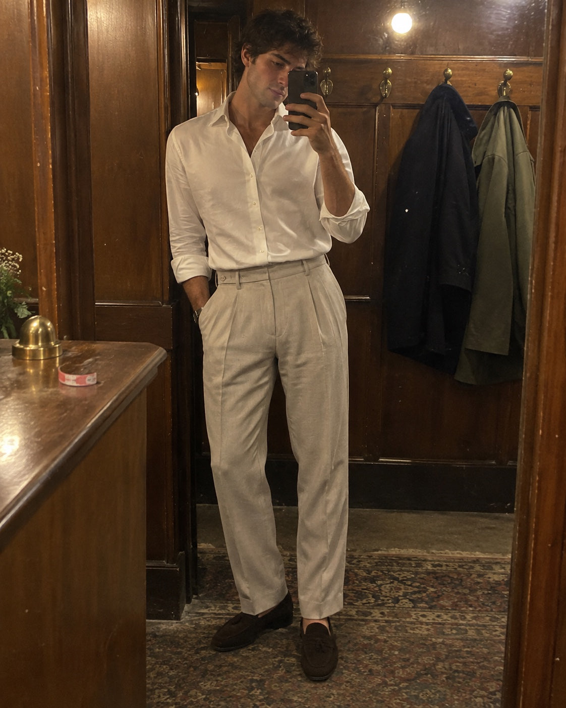 Customer wearing tailored trousers in a mirror